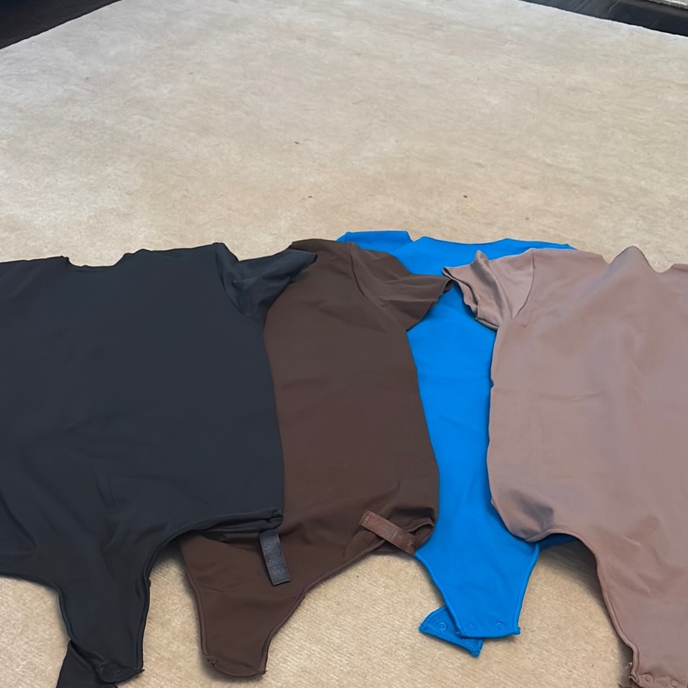 Set of Four Skims Essential Bodysuits in Black, Brown, Blue, and Tan size large